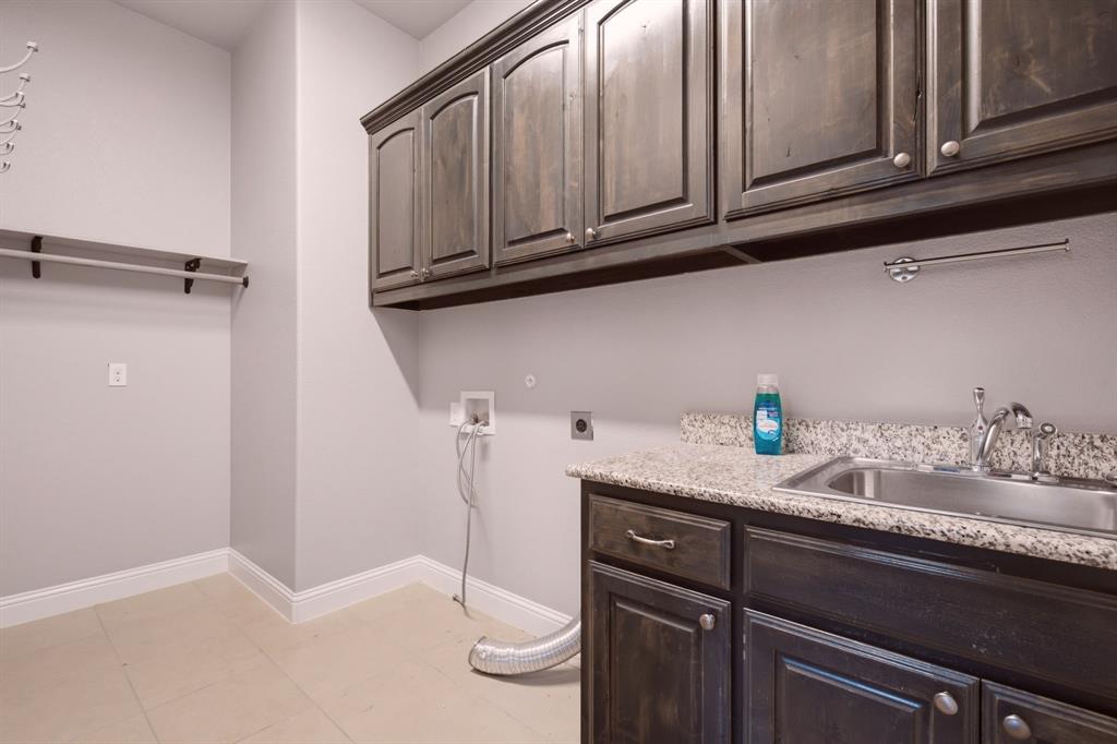 oversized laundry with sink and cabinets