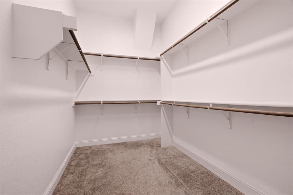 primary closet w built in shelving