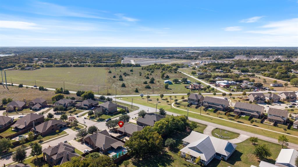 Aerial perspective featuring expansive residential surroundings, mature trees, and established infrastructure