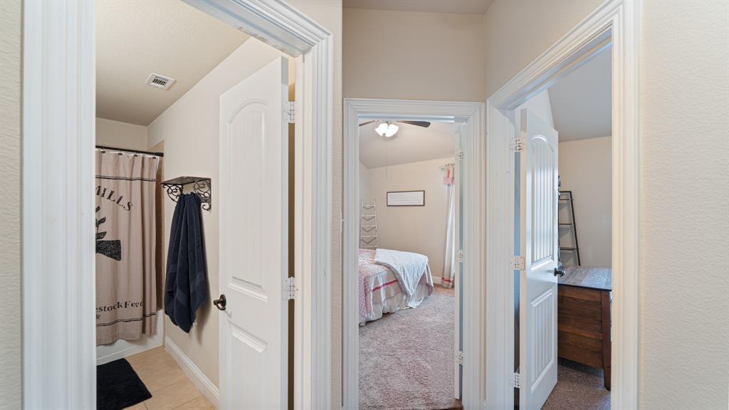 Hallway featuring three-panel arched interior doors, white door casing, and neutral wall tones
