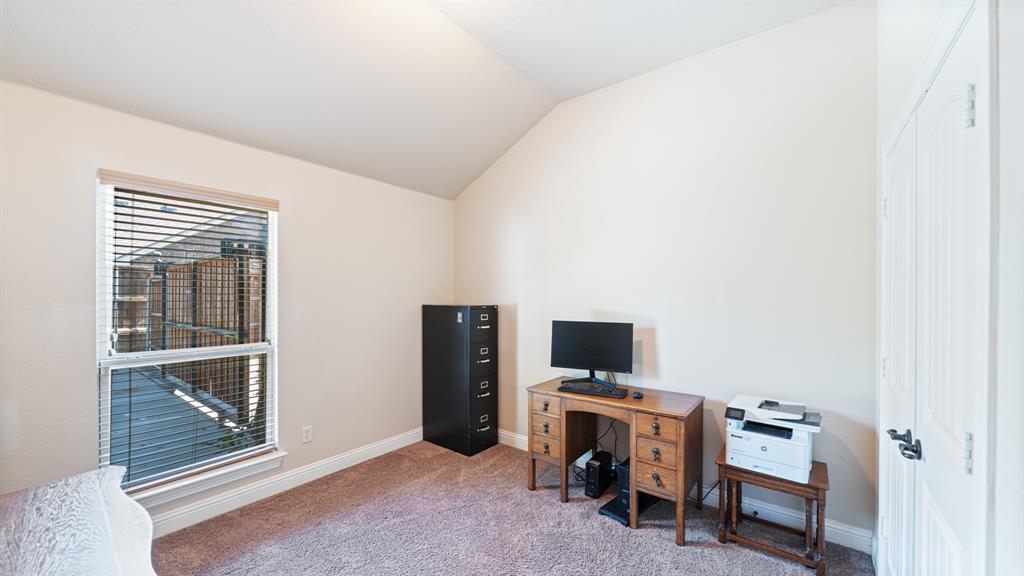 Vaulted ceiling, neutral wall tones, wall-to-wall carpeting, and a dual-panel closet door