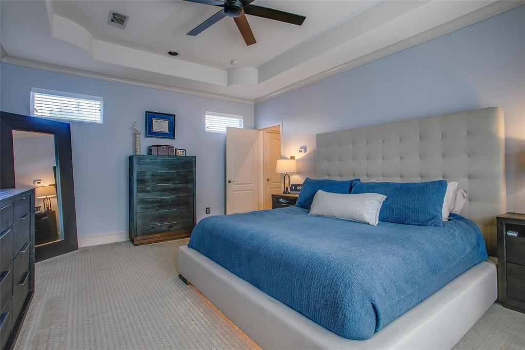 Carpeted room featuring a ceiling fan, recessed lighting, and a tray ceiling
