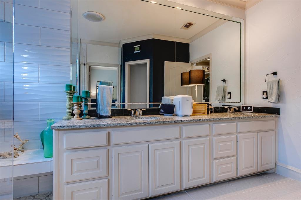 Dual vanity with a stone countertop and integrated sinks