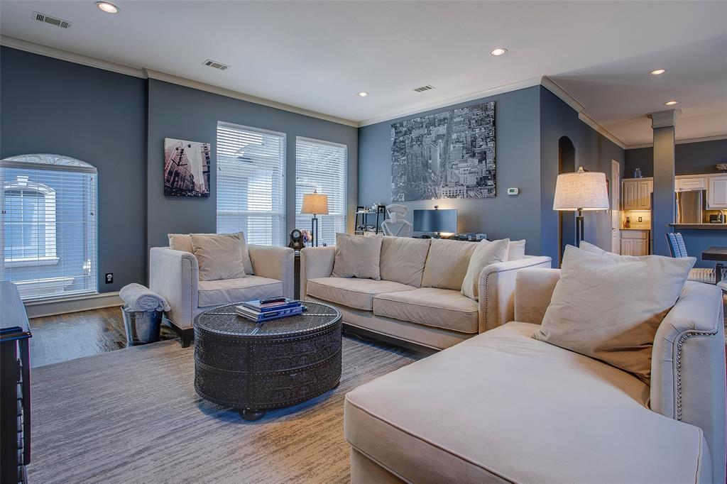 Spacious living area featuring recessed lighting, crown molding, multiple windows with horizontal blinds, and carpet flooring