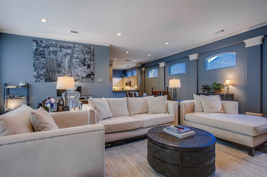 Living area with recessed lighting, crown molding, and architectural wall accents