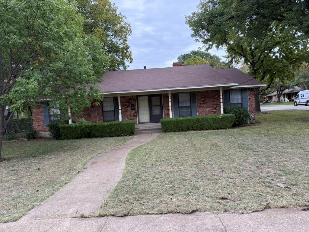 Single-story brick exterior featuring a covered front porch, gabled roofline, concrete walkway, and established landscaping Single-story brick exterior featuring a covered front porch, gabled roofline, concrete walkway, and established landscaping