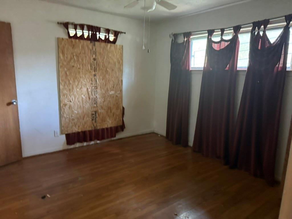 Wood-finish flooring, multi-pane windows, and a ceiling-mounted fan