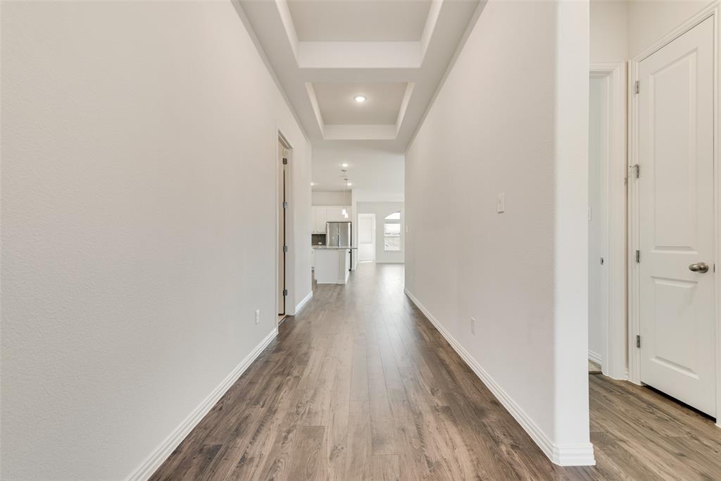 Hallway featuring coffered ceiling detail, wood-finish flooring, and recessed lighting