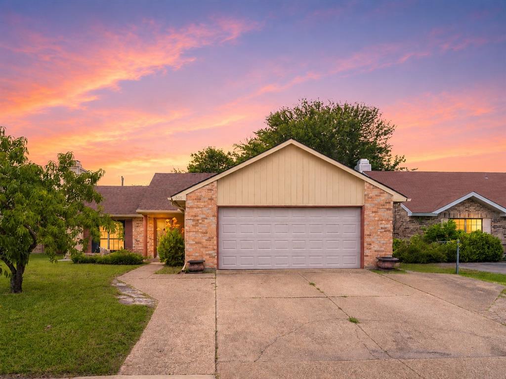 Single-story exterior featuring a brick facade, vertical siding, an attached two-car garage, and concrete driveway Single-story exterior featuring a brick facade, vertical siding, an attached two-car garage, and concrete driveway