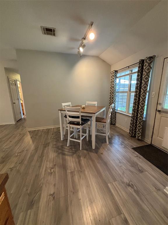 Dining area featuring wood-finish flooring, recessed lighting, and multi-pane window Dining area featuring wood-finish flooring, recessed lighting, and multi-pane window