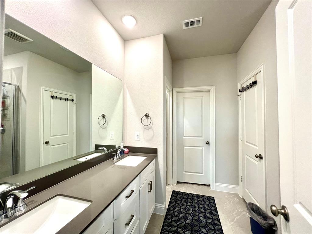 Bathroom featuring vanity and a shower with shower door