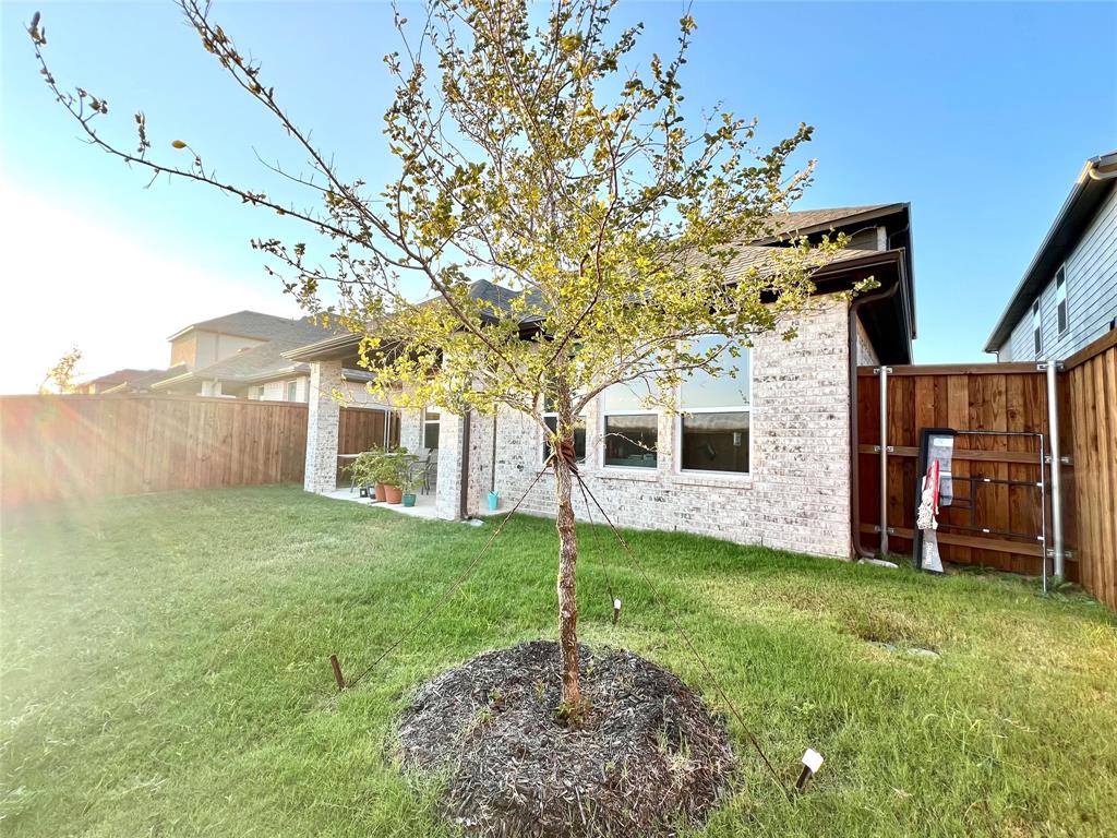Back of property featuring a yard
