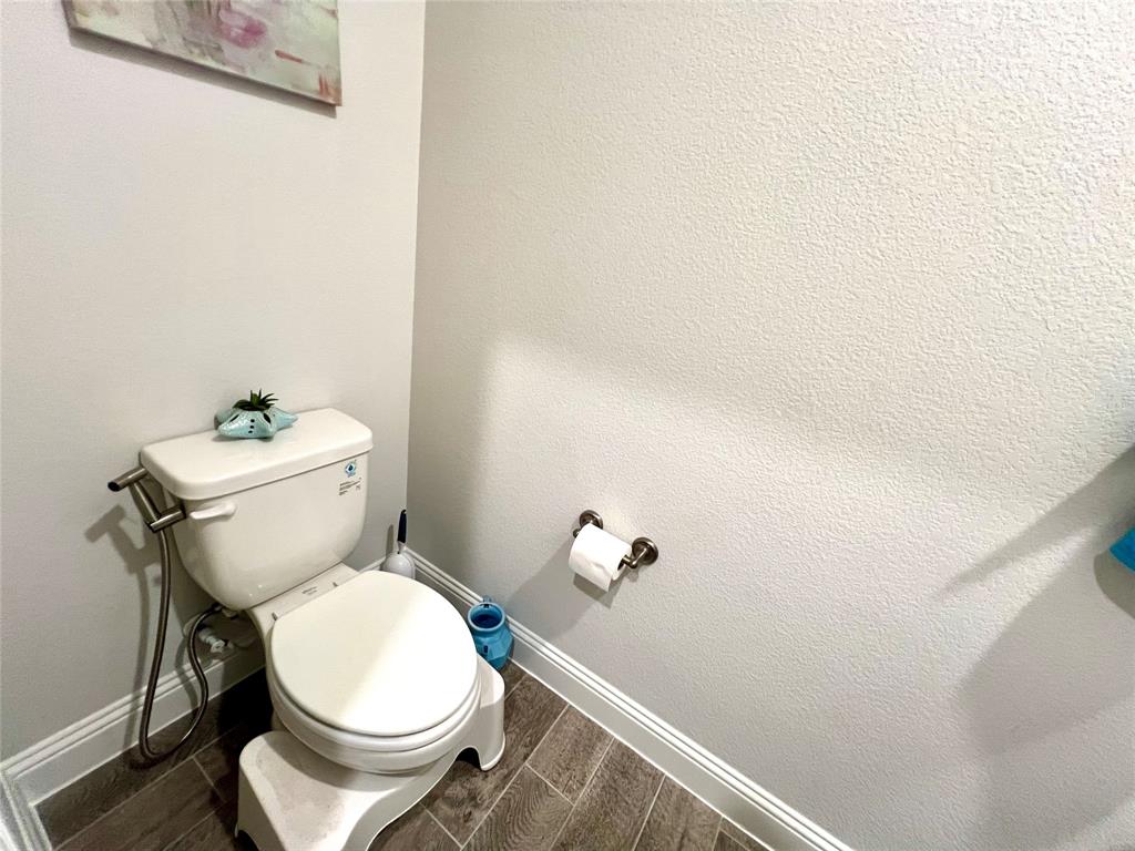 Bathroom with toilet and hardwood / wood-style floors