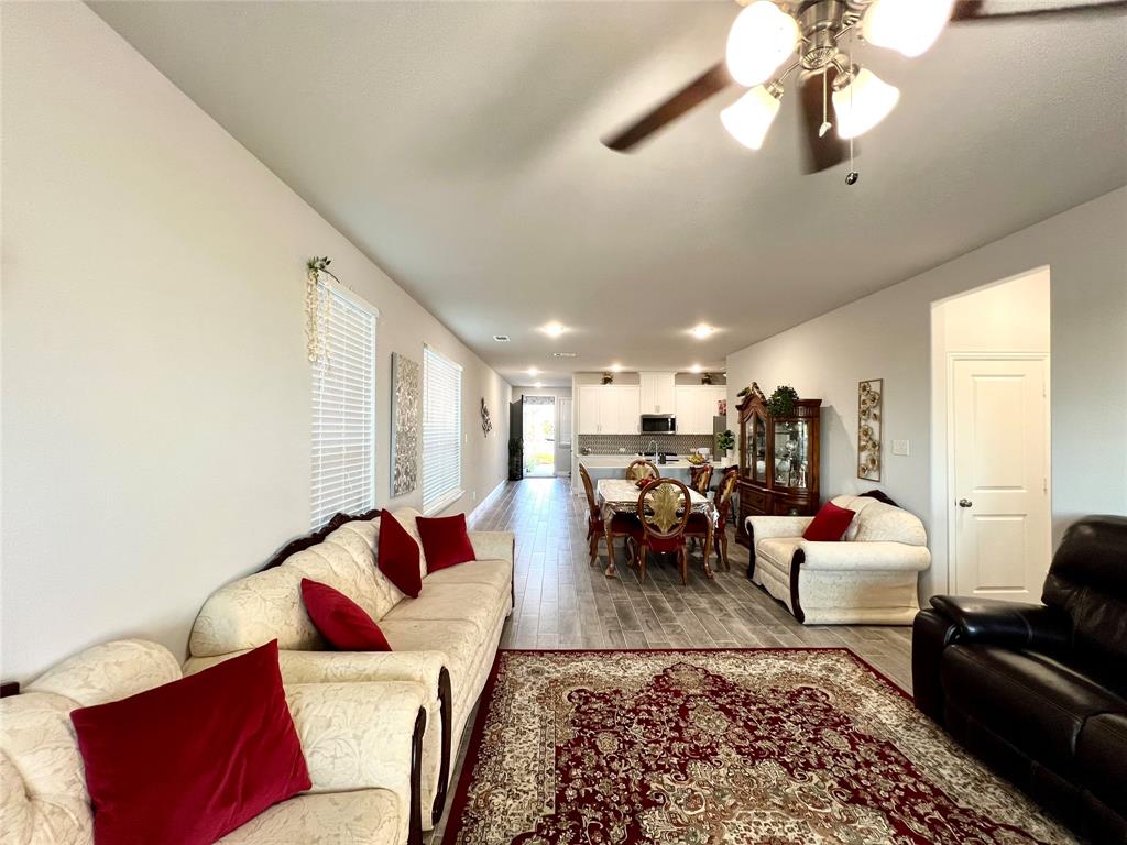 Living room featuring ceiling fan and hardwood / wood-style flooring