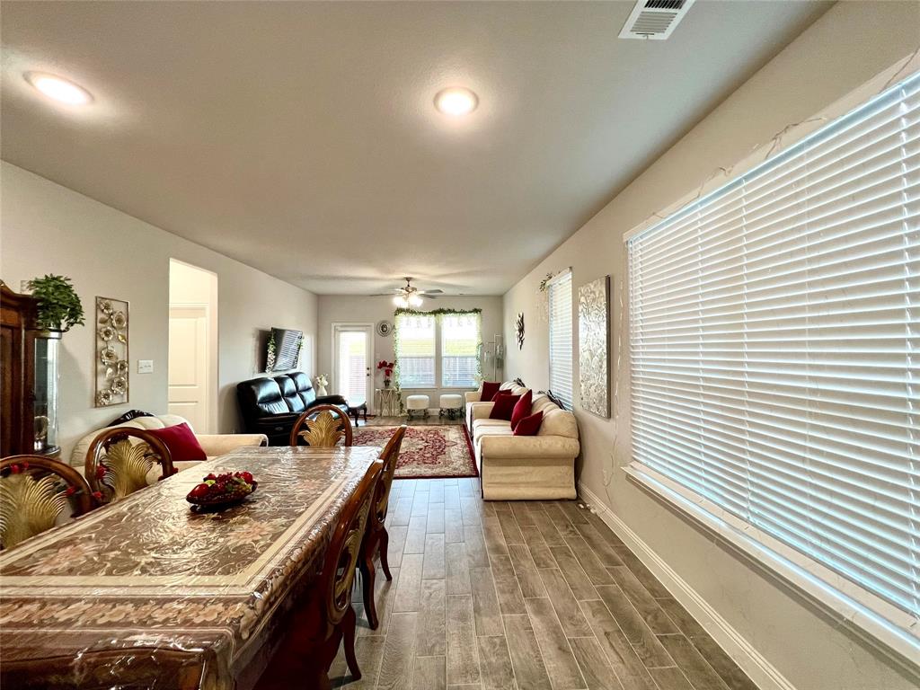 Dining space featuring wood-type flooring and ceiling fan