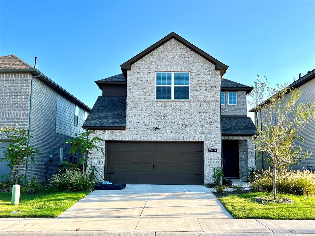 View of front of property with a garage and a front lawn View of front of property with a garage and a front lawn
