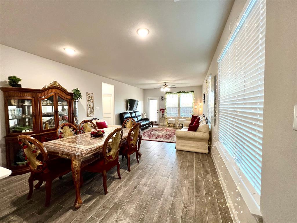 Dining area featuring wood-type flooring and ceiling fan