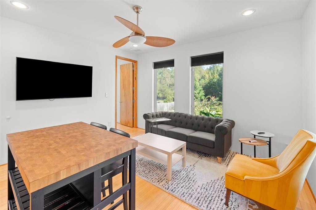 Interior featuring wood-finish flooring, recessed lighting, and a ceiling fan with integrated lighting