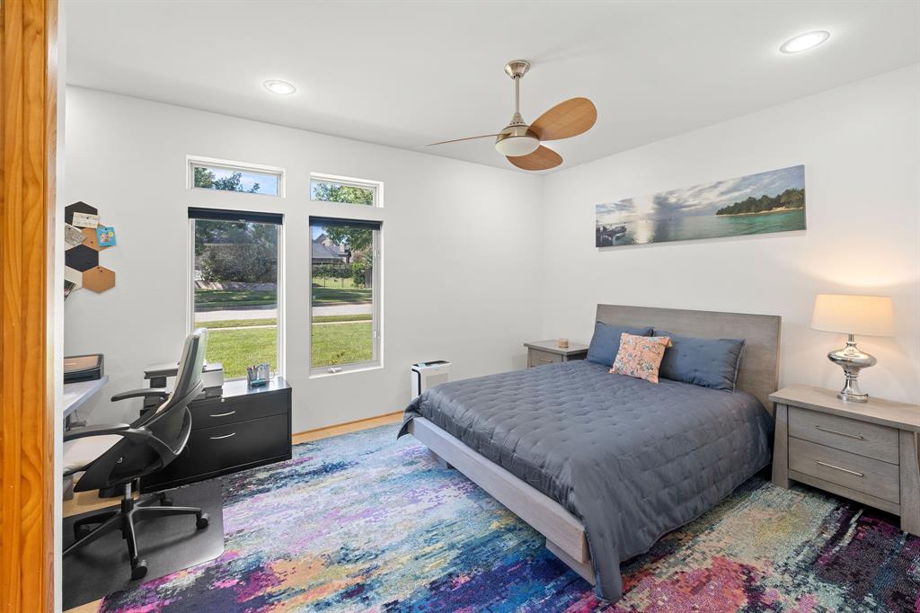 Spacious room featuring tall windows, recessed lighting, and a ceiling fan with wood-finish blades