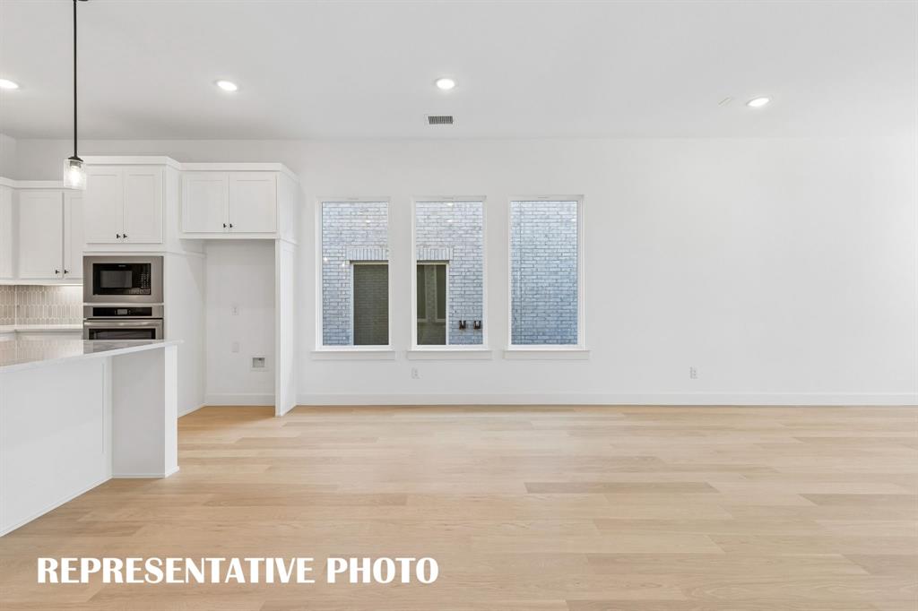 Conveniently located between the kitchen and family room, this light filled dining space is perfect for hosting lively dinner parties or cozy family get togethers.  REPRESENTATIVE PHOTO