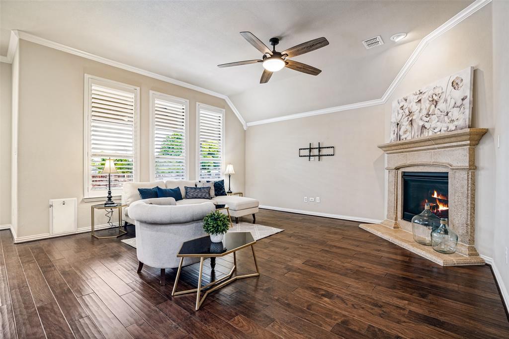 living room with gas fireplace overlooks back yard