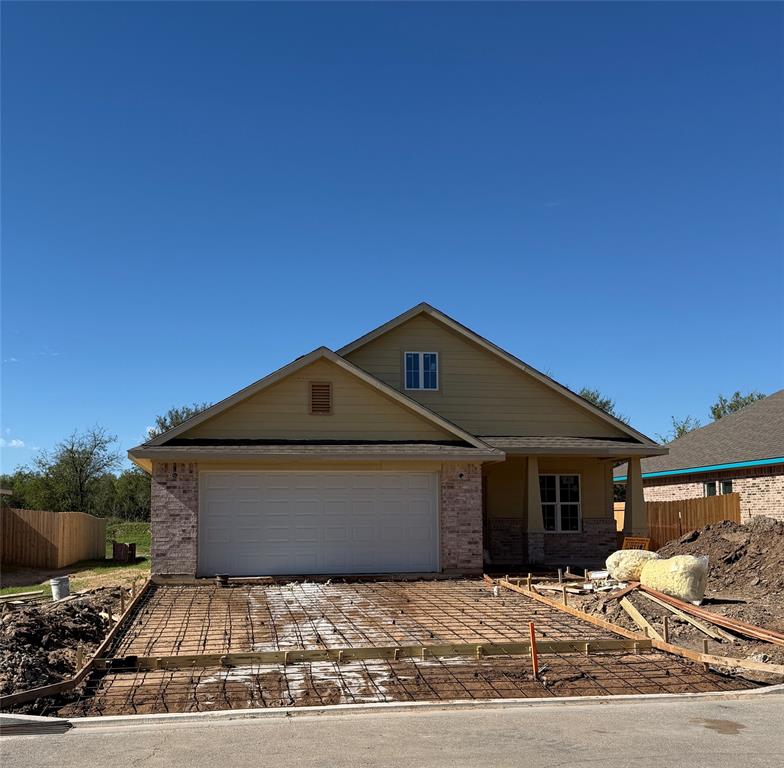 Single-story residence featuring a combination of brick and lap siding exterior, a two-car garage, and a covered front porch entry