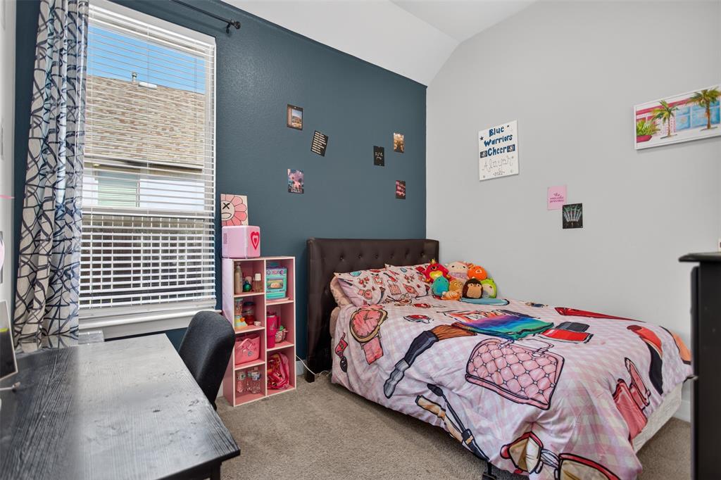 Room featuring high vaulted ceilings, a single deep-toned accent wall, neutral carpeting, and a large window with horizontal blinds
