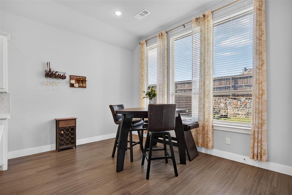 High ceilings featuring recessed lighting, expansive windows, and wood-finish flooring