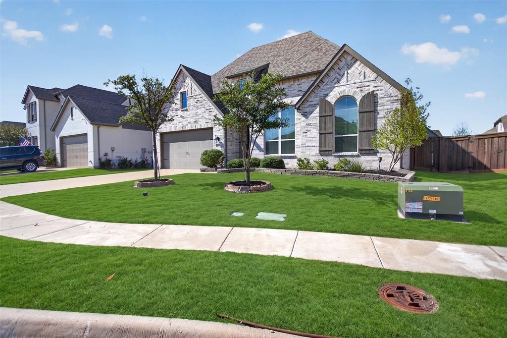 Stone and brick facade featuring arched windows, decorative wooden shutters, a multi-gabled roofline, and a paved driveway