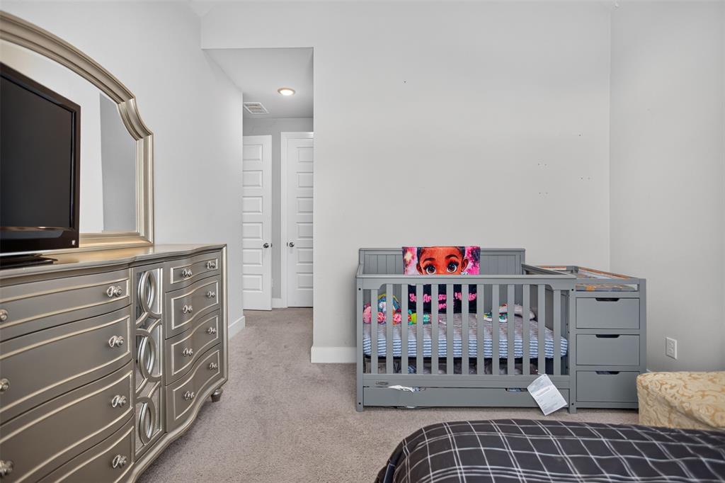 Neutral-toned interior featuring wall-to-wall carpeting, recessed lighting, and two multi-panel doors