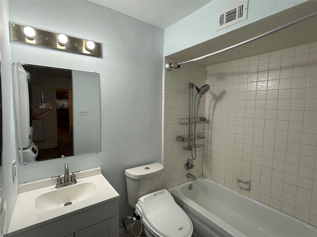 Bathroom with tub shower and vanity.