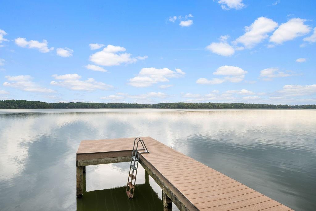 Private pier with composite decking and integrated metal ladder, extending over open water