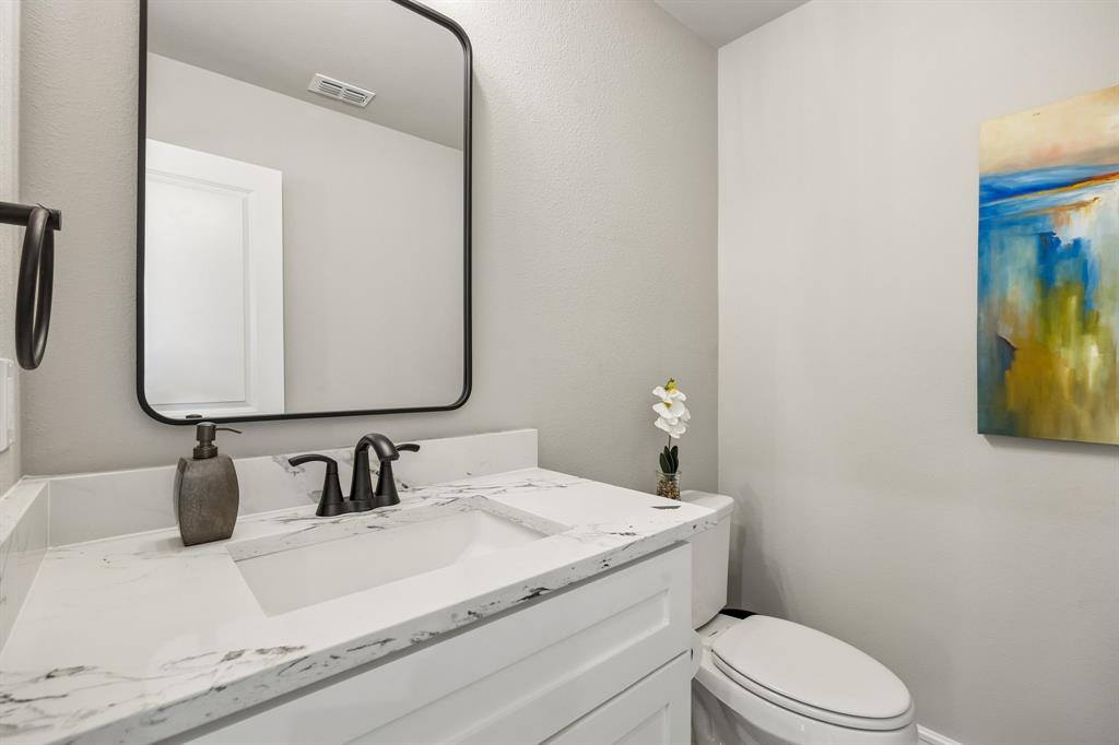 407 Frank quartz countertops in half bath and framed mirror