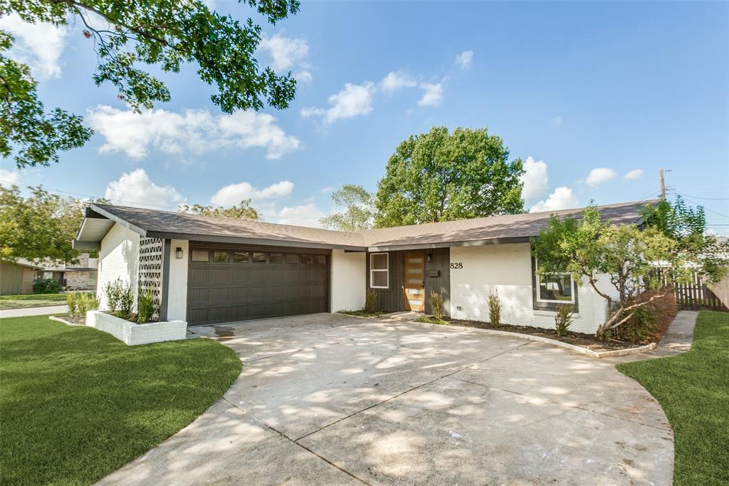 Mid-century modern exterior featuring a low-slope roof, painted brick facade, decorative breeze block accents, horizontal-paneled garage door, and a natural wood entry door