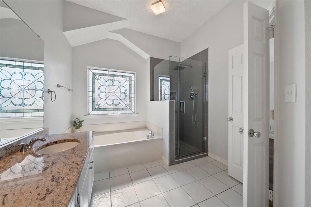 Primary bathroom with separate tub and shower