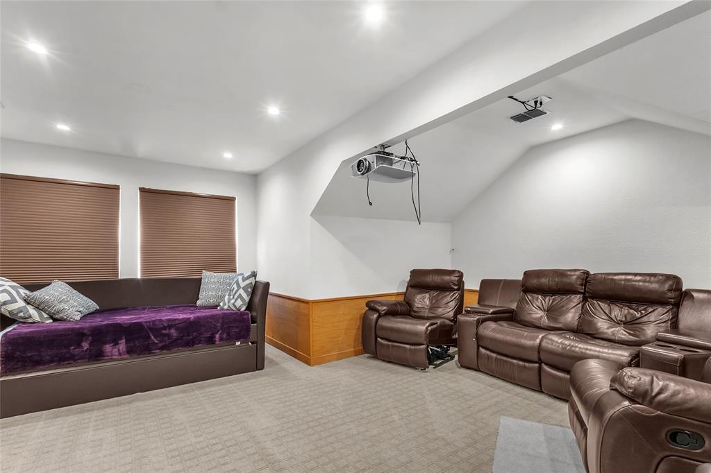 Upstairs media room with carpet, angled ceilings, and two windows — 5804 Lafayette Dr, Frisco
