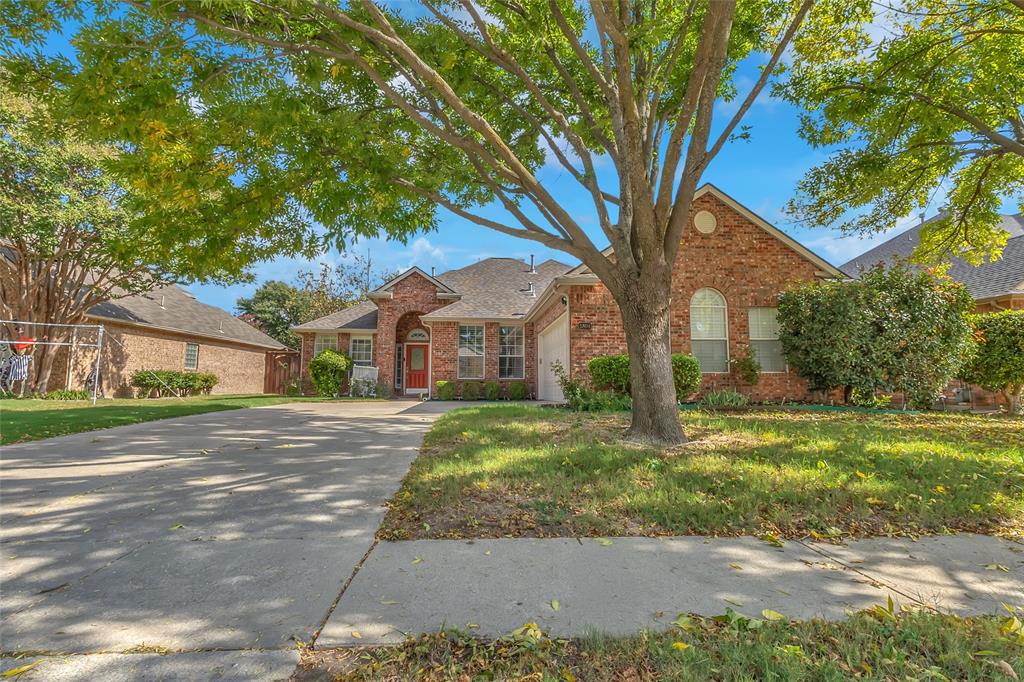 Brick front exterior with large shade tree and landscaped yard — 5804 Lafayette Dr, Frisco
