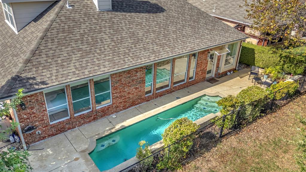 Aerial view of the backyard pool and iron fence along the golf course — 5804 Lafayette Dr, Frisco