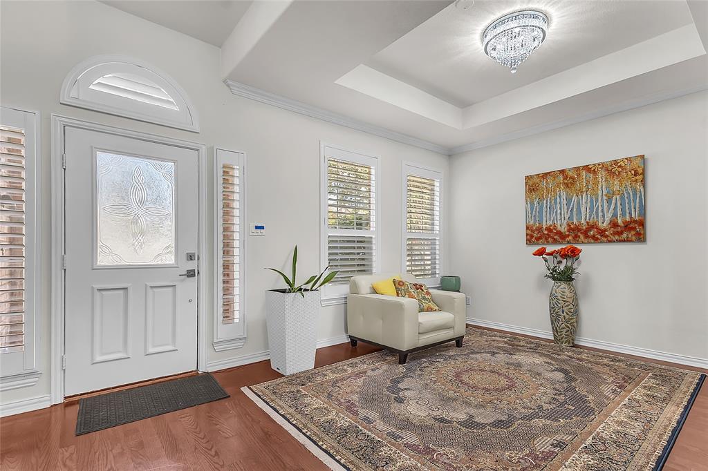 Entry with arched transom, sidelights, and front room chandelier — 5804 Lafayette Dr, Frisco