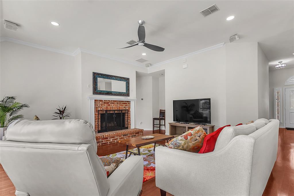 Living room with fireplace, crown molding, and recessed lighting — 5804 Lafayette Dr, Frisco