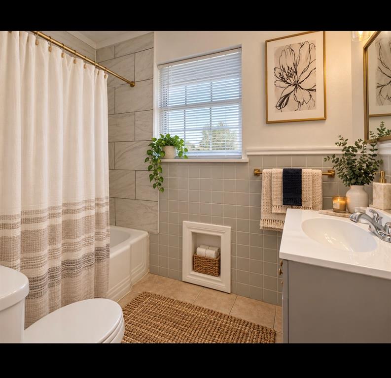 Bathroom featuring a vanity with a white countertop, wall-mounted inset storage niche, horizontal wall tiling, and a window with blinds*virtually staged*