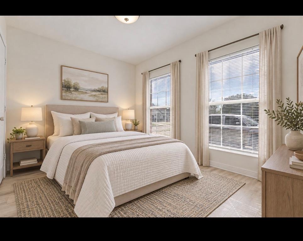 Room featuring neutral-toned walls, wood-finish flooring, two large windows, and a flush-mount ceiling light fixture *virtually staged*