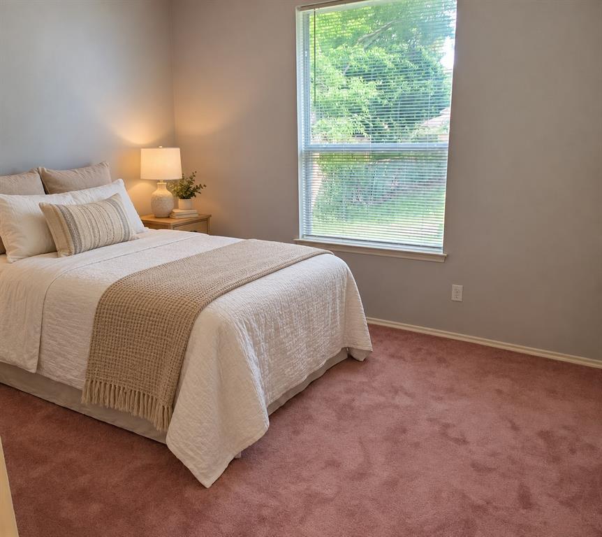 Neutral wall tones, wall-to-wall carpeting, and a single-pane window with horizontal blinds Neutral wall tones, wall-to-wall carpeting, and a single-pane window with horizontal blinds