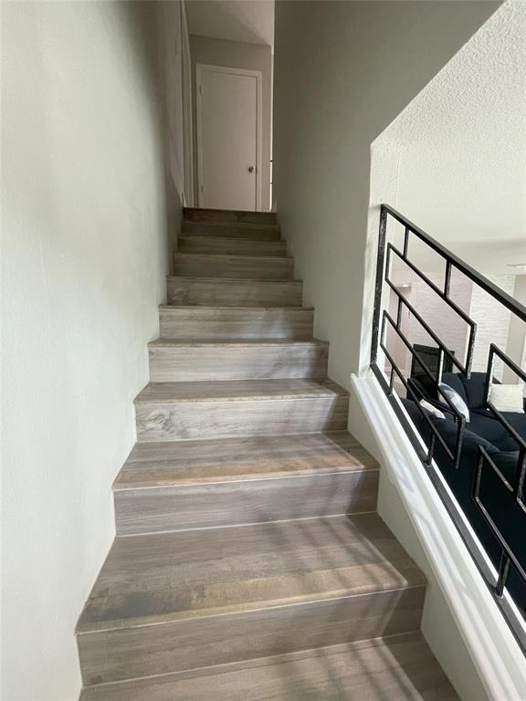 Stairs featuring wood-type flooring