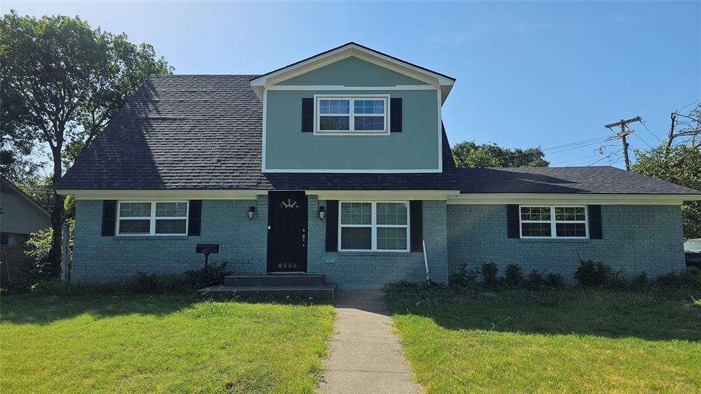 Front facade featuring a front lawn