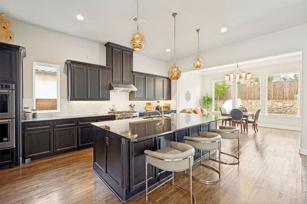 Expansive chef's kitchen features commercial 6 burner cooktop, double ovens plus an abundance of countertop and cabinet space - plus wait until you see this pantry!