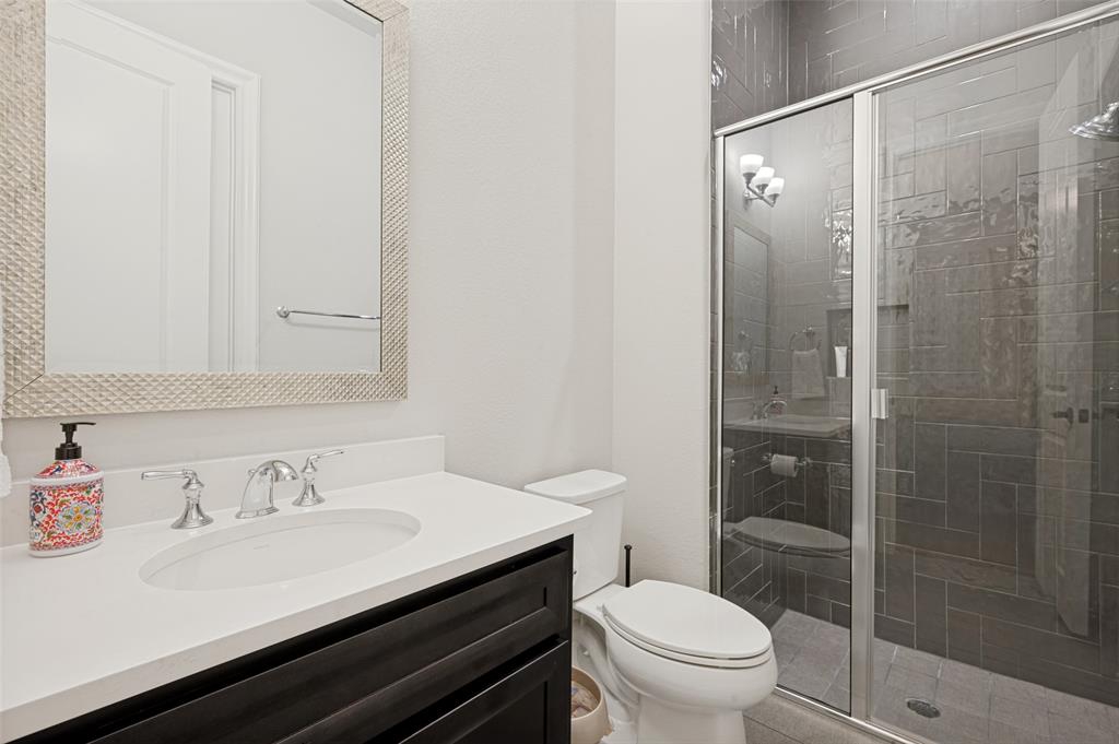 The downstairs guest room features this private full bath.
