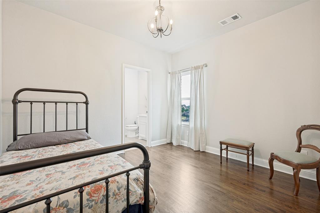 Another of three upstairs bedrooms. This one also features its own private ensuite and walk-in closet.