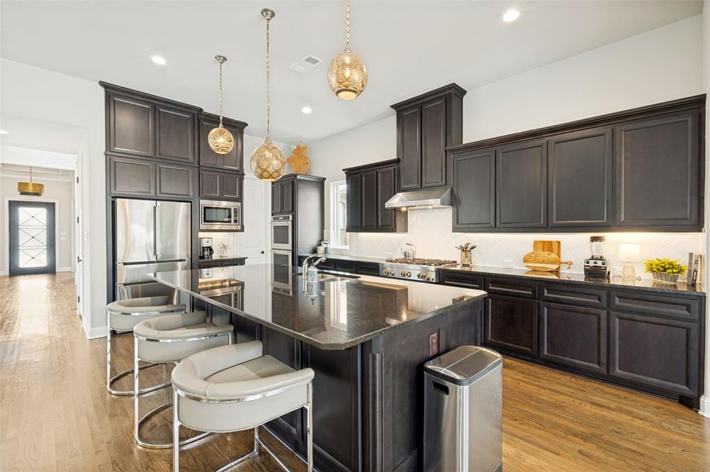 The rich cabinetry is is spacious and features dimmable under cabinet lighting and ample storage.