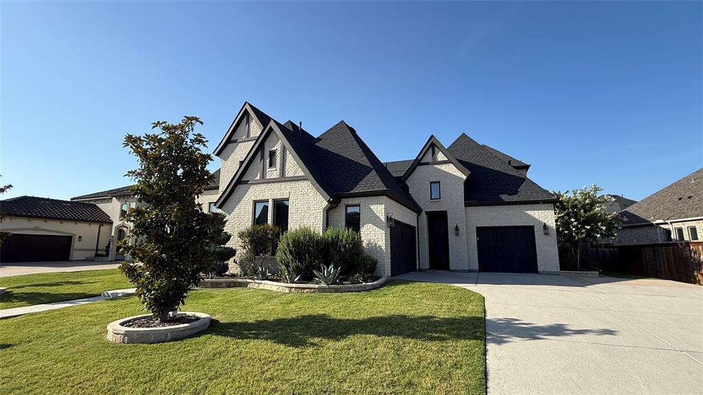 East side view of 2 car garage and separate single garage as well as a separate entrance to the private courtyard.